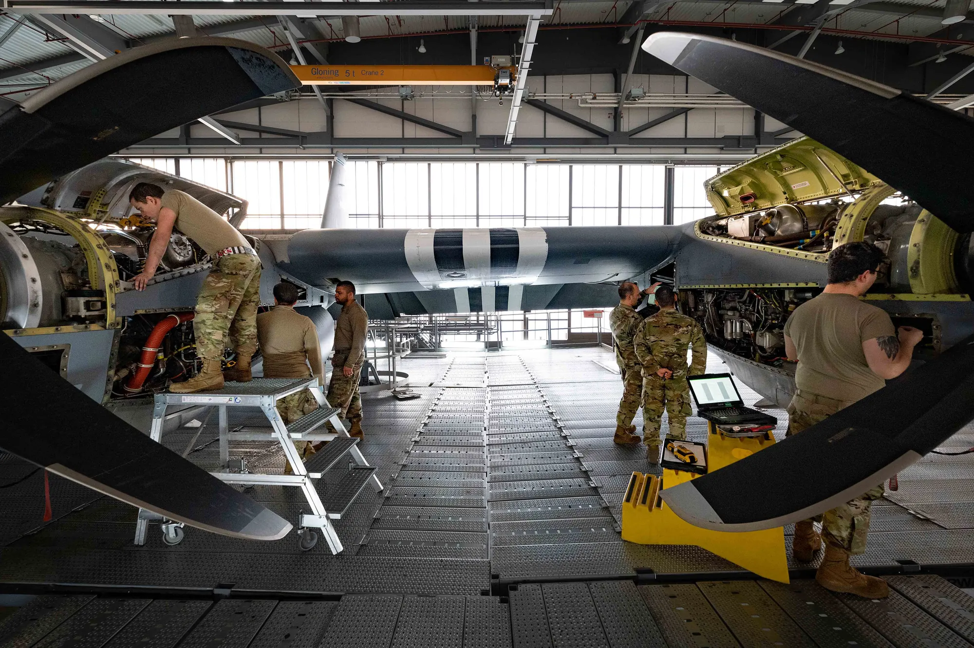 Engineers working on aircraft engines in a hangar